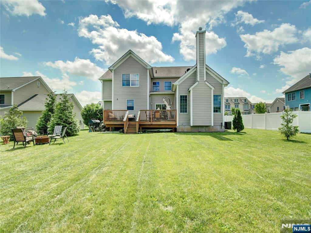 35 College Ave, East Orange, NJ 07017 - rear view of house with a fire pit, a chimney, and a deck