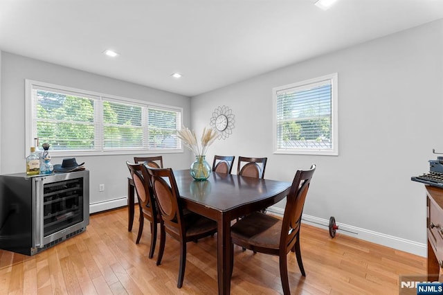 203 Central Ave, Bogota, NJ 07603 - dining area featuring light wood-type flooring, a baseboard radiator, recessed lighting, and beverage cooler