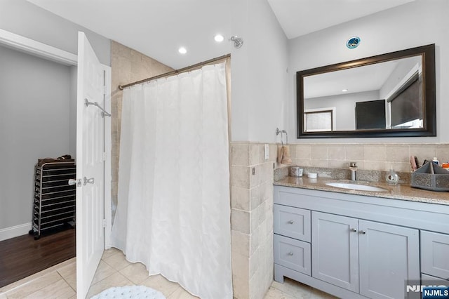 203 Central Ave, Bogota, NJ 07603 - bathroom featuring vanity, a shower with shower curtain, and tile walls