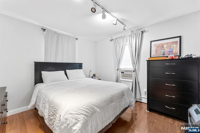 203 Central Ave, Bogota, NJ 07603 - bedroom with track lighting, wood-type flooring, cooling unit, and a baseboard radiator