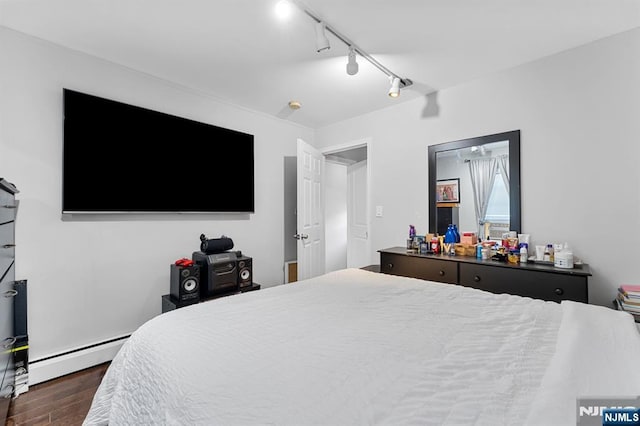 203 Central Ave, Bogota, NJ 07603 - bedroom featuring a baseboard heating unit, dark wood-type flooring, and track lighting