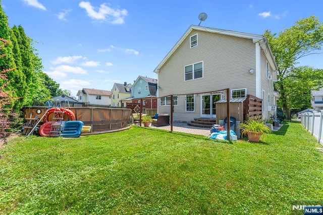 203 Central Ave, Bogota, NJ 07603 - rear view of house featuring a fenced backyard and a pool