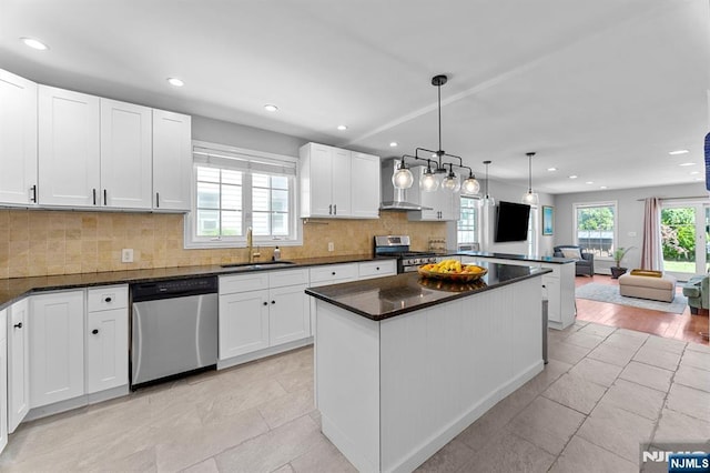 203 Central Ave, Bogota, NJ 07603 - kitchen with stainless steel appliances, recessed lighting, white cabinets, a kitchen island, and open floor plan