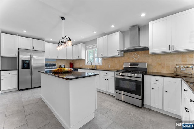 203 Central Ave, Bogota, NJ 07603 - kitchen featuring appliances with stainless steel finishes, wall chimney range hood, recessed lighting, white cabinets, and a center island