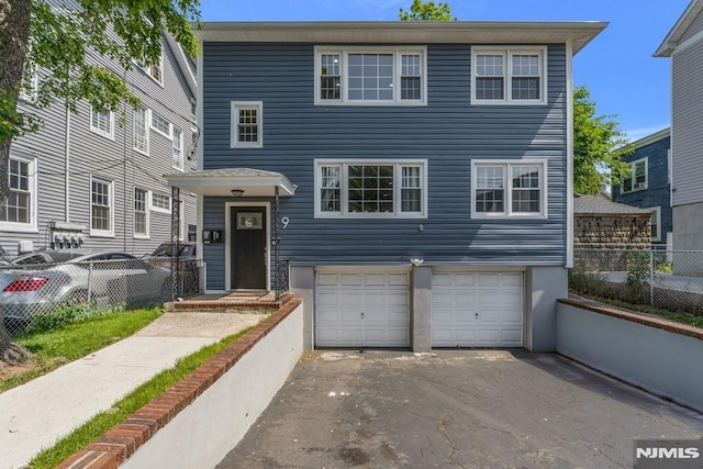 9 Westervelt Pl, Irvington, NJ 07111 - view of front of home with an attached garage and driveway