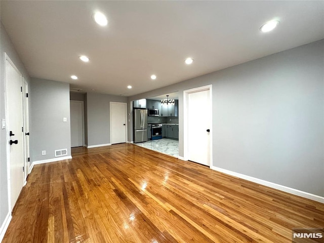 9 Westervelt Pl, Irvington, NJ 07111 - unfurnished living room featuring recessed lighting and light wood-style flooring