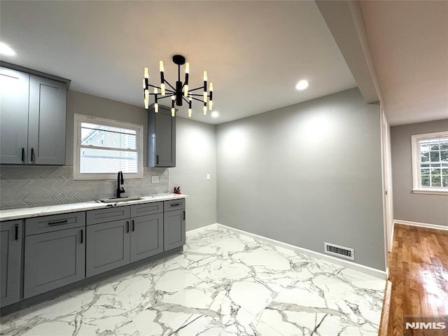 9 Westervelt Pl, Irvington, NJ 07111 - kitchen featuring gray cabinets, light countertops, a chandelier, tasteful backsplash, and recessed lighting