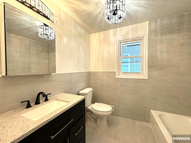 9 Westervelt Pl, Irvington, NJ 07111 - bathroom featuring vanity, a tub to relax in, tile walls, and marble finish flooring