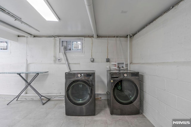9 Westervelt Pl, Irvington, NJ 07111 - laundry area featuring independent washer and dryer, plenty of natural light, and tile patterned flooring