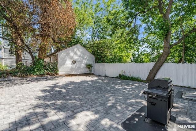 9 Westervelt Pl, Irvington, NJ 07111 - fenced backyard featuring grilling area, a patio area, and an outbuilding