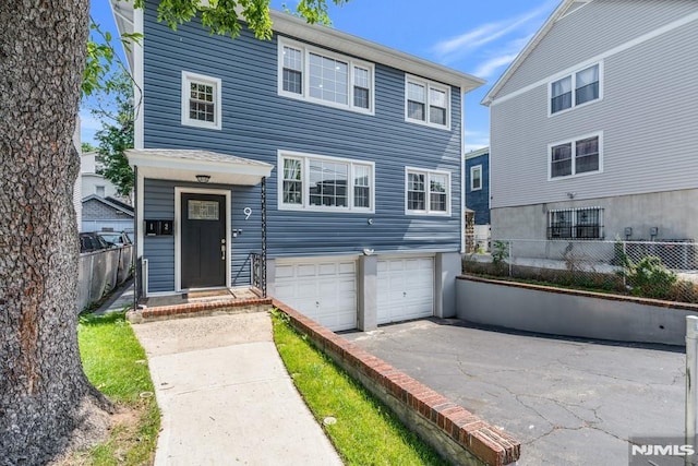 9 Westervelt Pl, Irvington, NJ 07111 - view of front of home featuring an attached garage and asphalt driveway