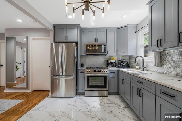 9 Westervelt Pl, Irvington, NJ 07111 - kitchen with appliances with stainless steel finishes, gray cabinets, light stone countertops, decorative backsplash, and recessed lighting