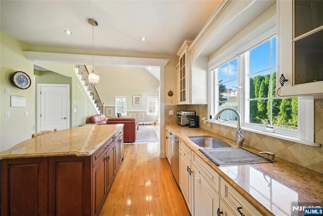 6 Highland Ave, Demarest, NJ 07627 - kitchen with tasteful backsplash, stainless steel dishwasher, decorative light fixtures, glass insert cabinets, and light stone counters