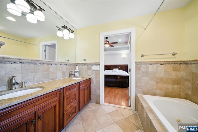 6 Highland Ave, Demarest, NJ 07627 - bathroom featuring tile walls, tile patterned floors, ensuite bathroom, a tub with jets, and double vanity