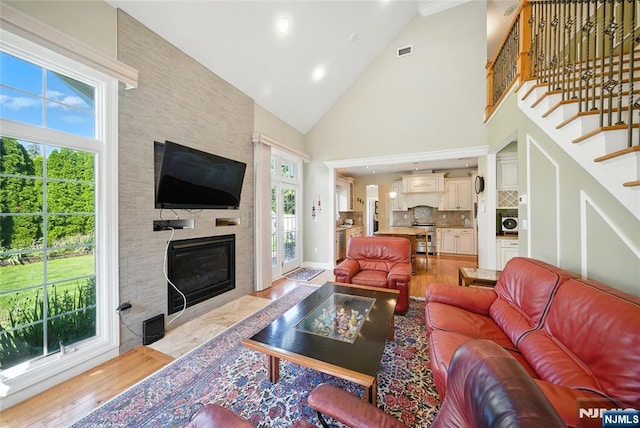 6 Highland Ave, Demarest, NJ 07627 - living room featuring high vaulted ceiling, light wood-style flooring, a large fireplace, recessed lighting, and stairs