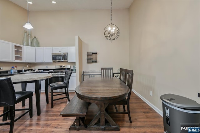 1066 Ash Dr, Mahwah, NJ 07430 - dining space featuring high vaulted ceiling, dark wood-style floors, a chandelier, and recessed lighting