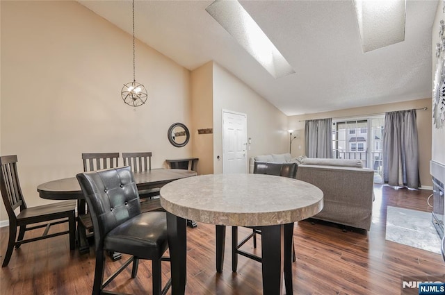 1066 Ash Dr, Mahwah, NJ 07430 - dining room with dark wood-style flooring, high vaulted ceiling, and a skylight