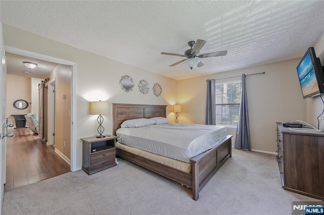 1066 Ash Dr, Mahwah, NJ 07430 - bedroom featuring a textured ceiling, light carpet, and a ceiling fan