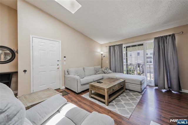 1066 Ash Dr, Mahwah, NJ 07430 - living room with vaulted ceiling, wood finished floors, a skylight, and a textured ceiling