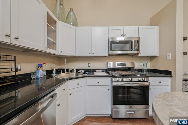 1066 Ash Dr, Mahwah, NJ 07430 - kitchen featuring appliances with stainless steel finishes, white cabinetry, glass insert cabinets, and dark wood-style flooring