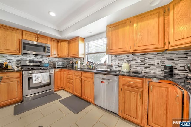 79 Newark Ave, Bloomfield, NJ 07003 - kitchen with stainless steel appliances, dark countertops, tasteful backsplash, recessed lighting, and brown cabinets
