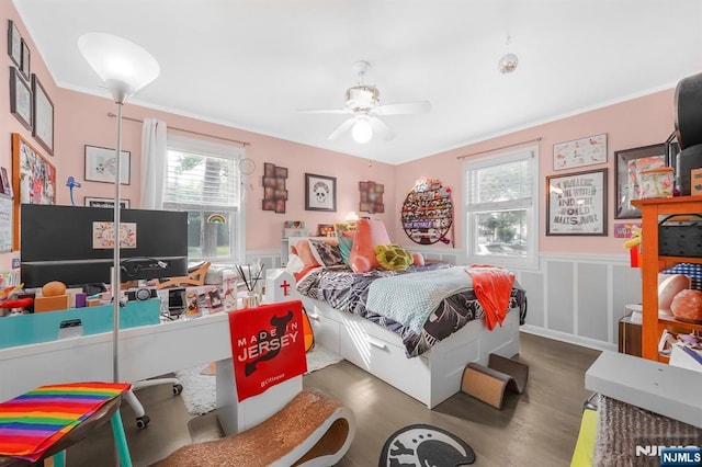 79 Newark Ave, Bloomfield, NJ 07003 - bedroom with multiple windows, wood finished floors, a wainscoted wall, ornamental molding, and a decorative wall
