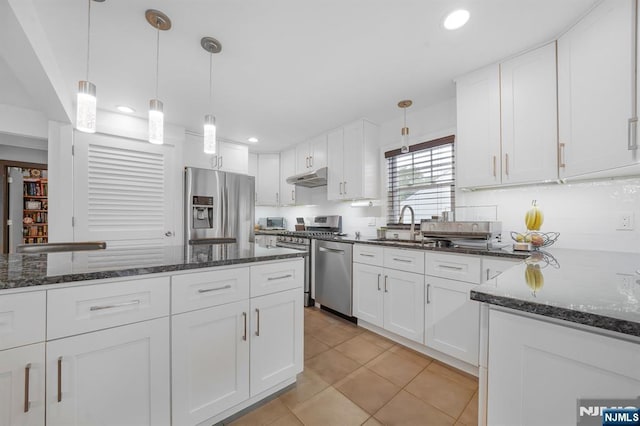 79 Newark Ave, Bloomfield, NJ 07003 - kitchen featuring stainless steel appliances, under cabinet range hood, white cabinets, backsplash, and recessed lighting