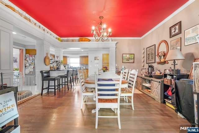 79 Newark Ave, Bloomfield, NJ 07003 - dining room with ornate columns, a chandelier, crown molding, and wood finished floors