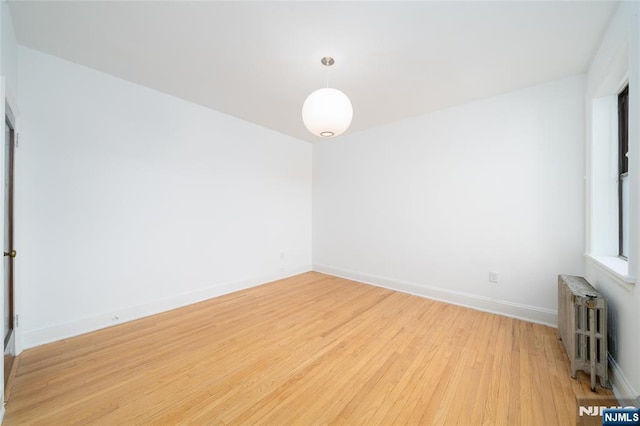 1100 83rd St Unit 301, North Bergen, NJ 07047 - spare room with radiator heating unit and light wood finished floors