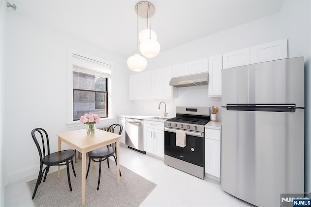 1100 83rd St Unit 301, North Bergen, NJ 07047 - kitchen featuring appliances with stainless steel finishes, ventilation hood, white cabinets, light countertops, and pendant lighting