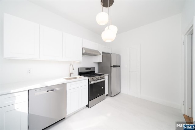 1100 83rd St Unit 301, North Bergen, NJ 07047 - kitchen featuring stainless steel appliances, wall chimney exhaust hood, white cabinetry, light countertops, and pendant lighting