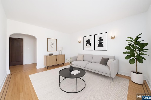 1100 83rd St Unit 301, North Bergen, NJ 07047 - living area with arched walkways and light wood-type flooring