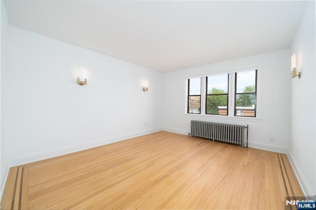 1100 83rd St Unit 301, North Bergen, NJ 07047 - spare room with radiator and light wood finished floors
