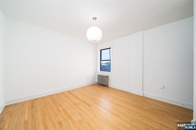 1100 83rd St Unit 301, North Bergen, NJ 07047 - unfurnished room featuring radiator and light wood-style floors