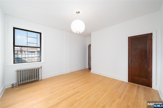 1100 83rd St Unit 301, North Bergen, NJ 07047 - spare room featuring radiator and light wood-style floors