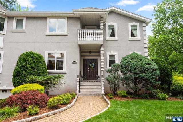 216 8th St, Cresskill, NJ 07626 - townhome / multi-family property featuring a balcony, stucco siding, and a front yard