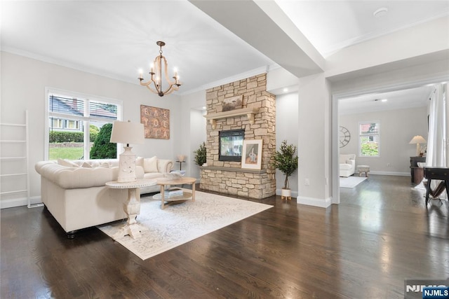 216 8th St, Cresskill, NJ 07626 - living room featuring crown molding, a chandelier, dark wood-style flooring, and a stone fireplace