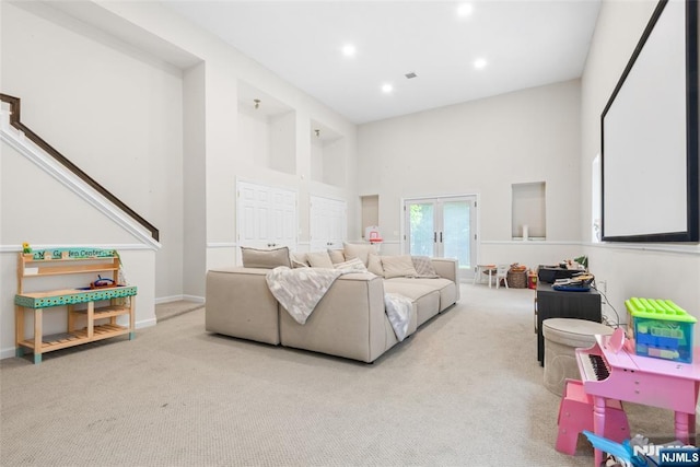 216 8th St, Cresskill, NJ 07626 - carpeted living area with french doors, a high ceiling, and recessed lighting