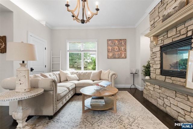 216 8th St, Cresskill, NJ 07626 - living room featuring dark wood-style floors, a chandelier, crown molding, and a stone fireplace