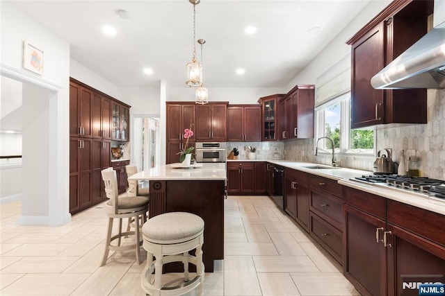 216 8th St, Cresskill, NJ 07626 - kitchen featuring wall chimney range hood, a kitchen island, light countertops, appliances with stainless steel finishes, and backsplash