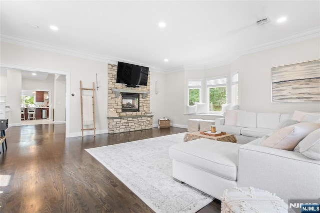216 8th St, Cresskill, NJ 07626 - living room with recessed lighting, dark wood-style flooring, crown molding, and a stone fireplace