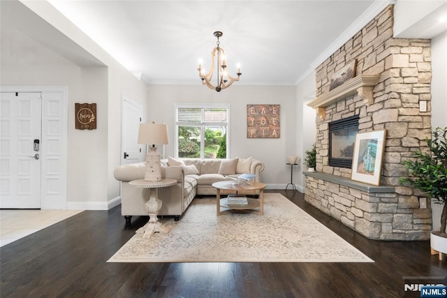 216 8th St, Cresskill, NJ 07626 - living room featuring a chandelier, wood finished floors, crown molding, and a stone fireplace