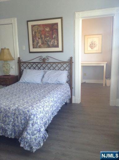 17 48th St, Weehawken, NJ 07086 - bedroom with wood finished floors and baseboards