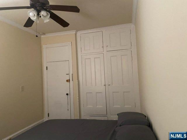 17 48th St, Weehawken, NJ 07086 - bedroom featuring a closet, ornamental molding, and ceiling fan