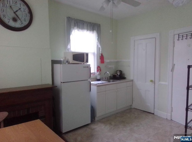 17 48th St, Weehawken, NJ 07086 - kitchen featuring white appliances, white cabinets, a ceiling fan, light flooring, and light countertops