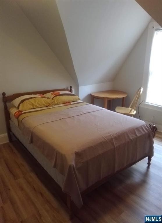 17 48th St, Weehawken, NJ 07086 - bedroom with wood finished floors and lofted ceiling