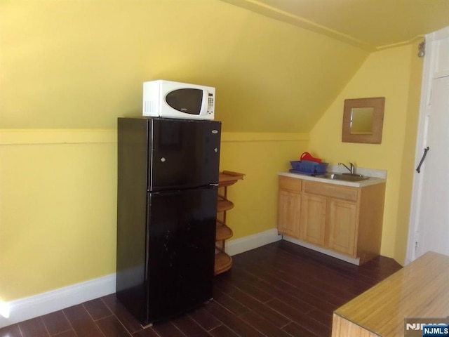 17 48th St, Weehawken, NJ 07086 - kitchen with freestanding refrigerator, white microwave, dark wood-type flooring, light brown cabinetry, and lofted ceiling