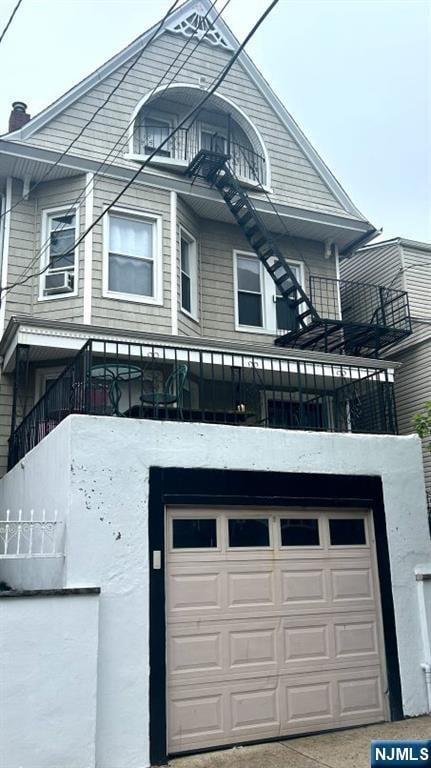 17 48th St, Weehawken, NJ 07086 - view of front of property with a balcony, a garage, stairway, and cooling unit