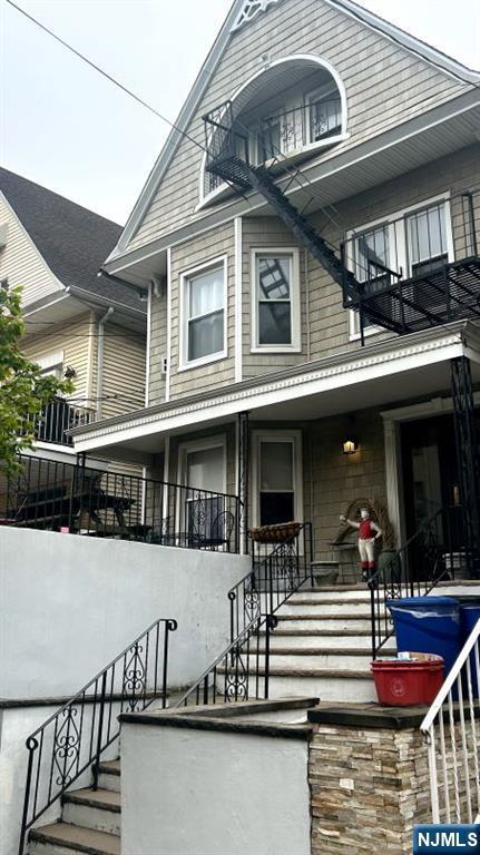 17 48th St, Weehawken, NJ 07086 - view of front of property with stairs and a balcony