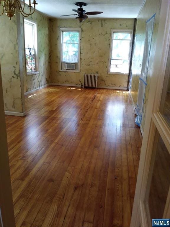 17 48th St, Weehawken, NJ 07086 - unfurnished room with radiator, hardwood / wood-style floors, a chandelier, and cooling unit